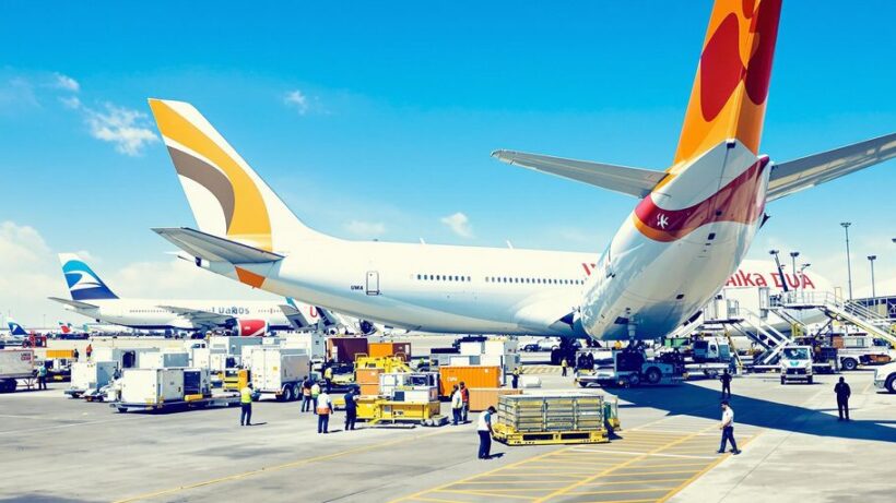 Air cargo facility with planes and ground crew in UAE.